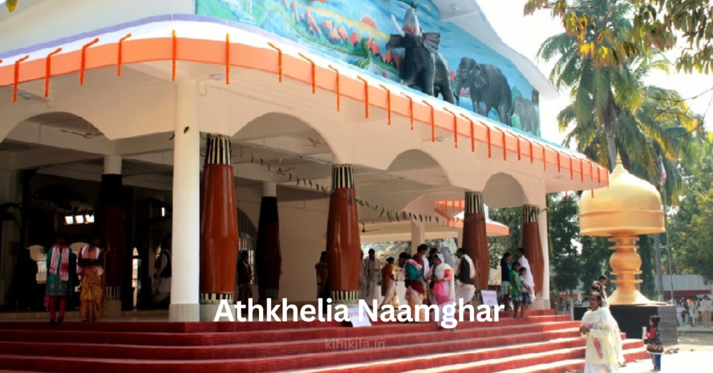 Athkhelia Naamghar: An Enchanting Sacred Heritage of Assam Athkhelia Naamghar Athkhelia Naamghar, a prominent religious site in Assam, featuring traditional Assamese architecture with large wooden pillars, a mural of elephants, and a golden dome structure in the courtyard. Devotees dressed in traditional attire are seen entering the Naamghar.