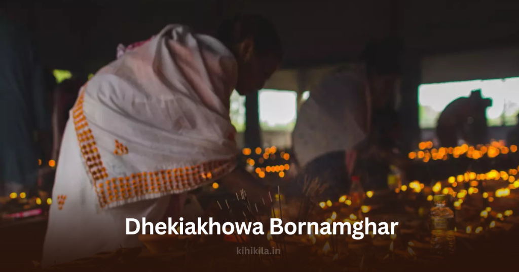 A devotee dressed in a traditional Assamese mekhela sador lighting earthen lamps at Dhekiakhowa Bornamghor, a revered prayer hall in Assam, India.