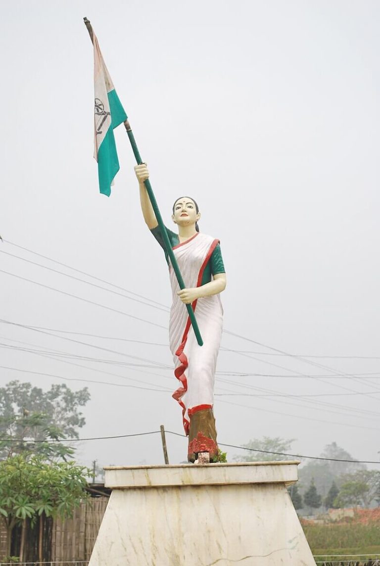 A statue of Kanaklata Barua holding the Indian National Flag, symbolizing her courage and sacrifice during the Quit India Movement in 1942.