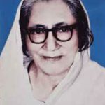 A portrait of Nalini Bala Devi, an eminent Assamese poet, wearing a white saree and glasses, known for her profound literary contributions.
