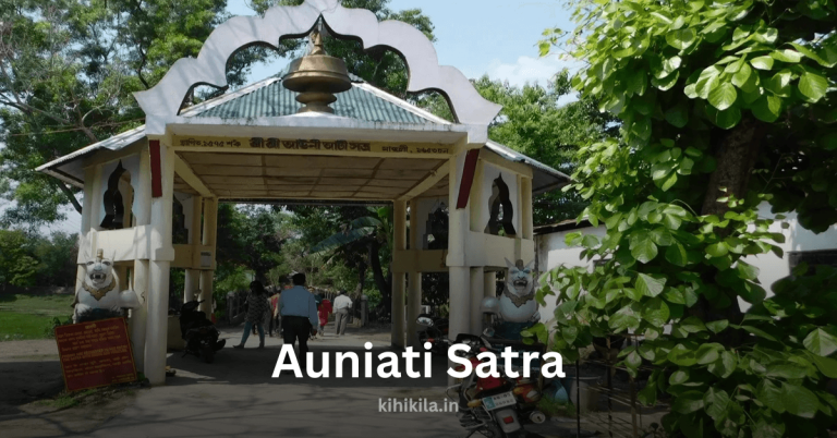 Entrance of Auniati Satra, a historic Vaishnavite monastery in Assam, surrounded by greenery and featuring traditional Assamese architectural elements.