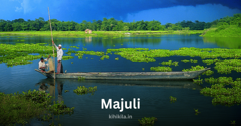 A scenic view of Majuli island in Assam, India, featuring two fishermen on a wooden boat amidst lush green water plants and a peaceful river landscape.