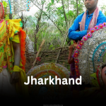 Traditional tribal performers in vibrant attire during a folk festival in Jharkhand.