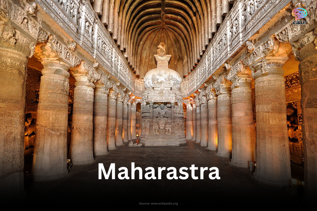 Ornate interior view of Ajanta Caves with carved pillars and a stupa.