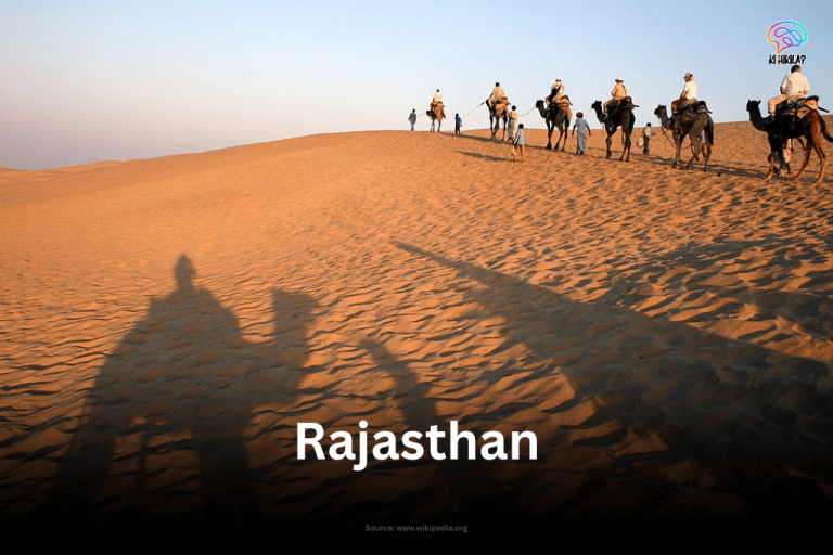 Camels and people silhouetted against a sand dune in the Thar Desert, Jaisalmer, Rajasthan, with the word "Rajasthan" overlayed.