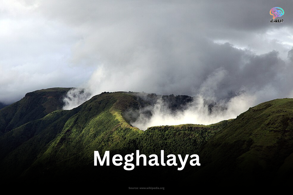 Mist and clouds rolling over lush green hills in Meghalaya.
