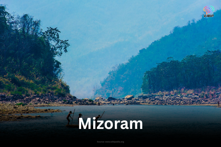 Fishermen in the tranquil Tuipui river, surrounded by forested hills in Mizoram.