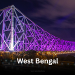 The iconic Howrah Bridge in Kolkata, West Bengal, brilliantly illuminated with purple lights against the dark night sky.