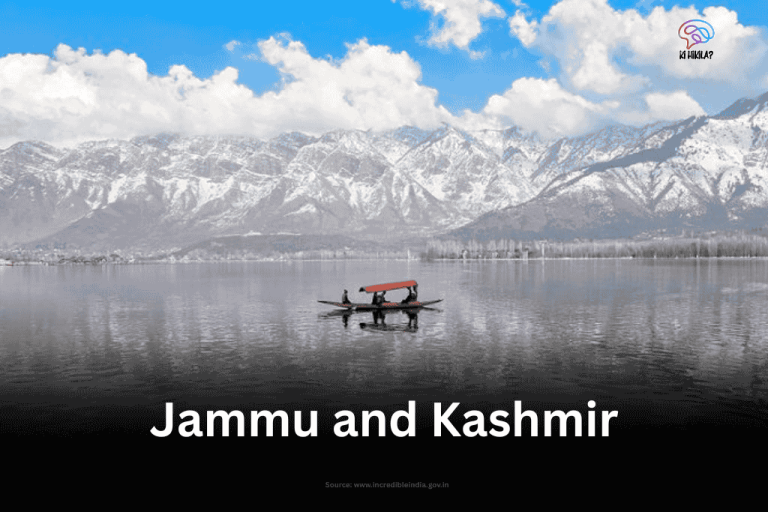 A lone shikara glides on the serene, reflective waters of Dal Lake, framed by majestic, snow-capped mountains in Jammu and Kashmir.