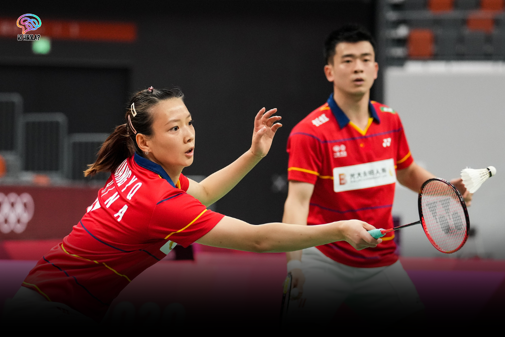Badminton: An Olympic Sport of Speed, Skill, and Strategy GATE Online Form A female and a male badminton player in red and yellow jerseys on a court, preparing to hit a shuttlecock, representing Badminton in Olympic.