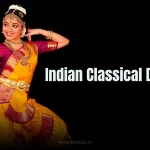 A woman in a traditional costume performing an Indian classical dance pose.