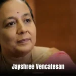 Jayshree Vencatesan: A colorful portrait of a woman in a saree holding a microphone, with a backdrop of ocean waves.
