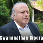 MS Swaminathan Biography: A thoughtful portrait of an elderly man in a suit, holding a book, with a background of green fields and rice plants.