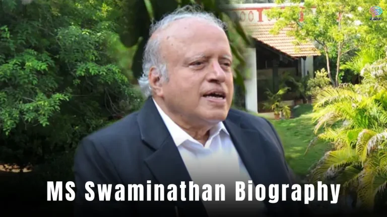 MS Swaminathan Biography: A thoughtful portrait of an elderly man in a suit, holding a book, with a background of green fields and rice plants.
