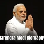 Narendra Modi Biography: A dynamic photo of a man in a traditional kurta, addressing a large crowd with a microphone, against a backdrop of the Indian flag.
