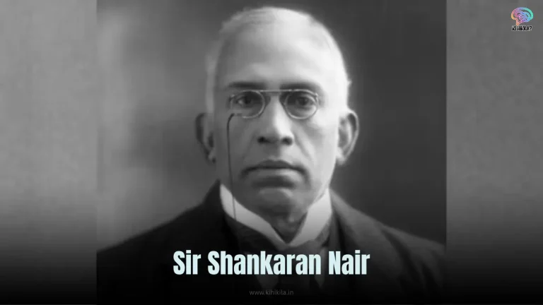 Sir Shankaran Nair: A vintage black-and-white photo of a man in a suit and turban, standing with a book in hand.