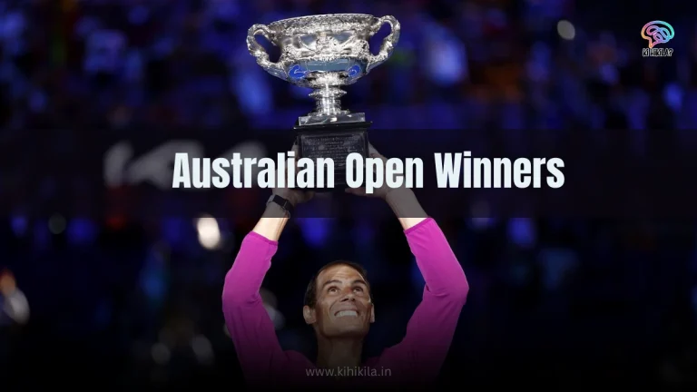 Ultimate List of Australian Open Winners: A jubilant tennis player in a pink shirt raising a silver trophy with both hands, smiling against a blurred blue-lit crowd background.