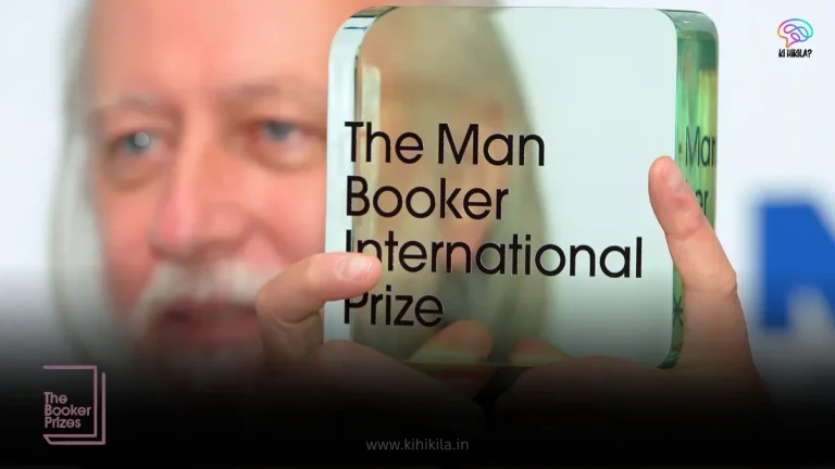 A person's hands holding the transparent, glass trophy for "The Man Booker International Prize.